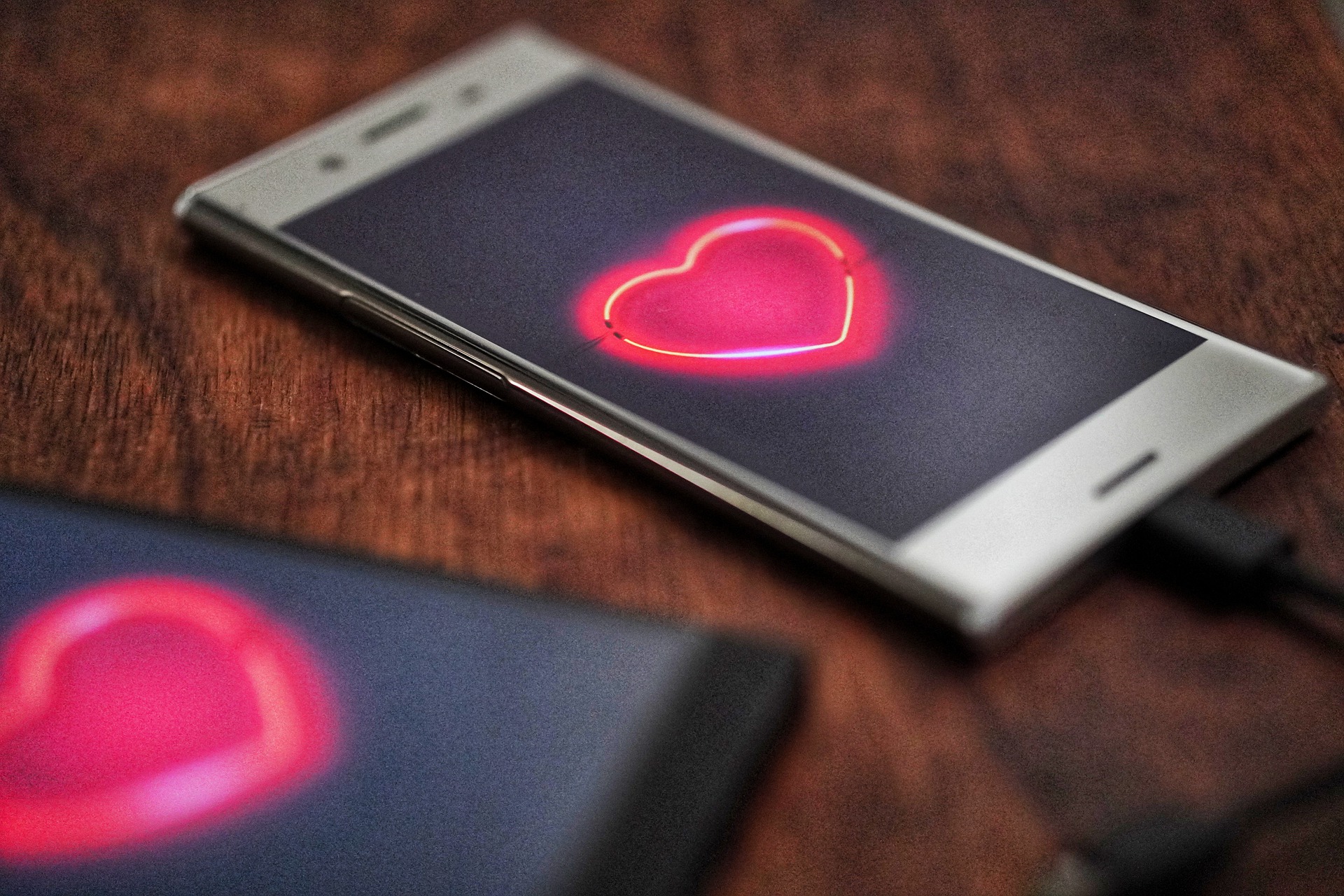 A smartphone with an image of a heart on its screen