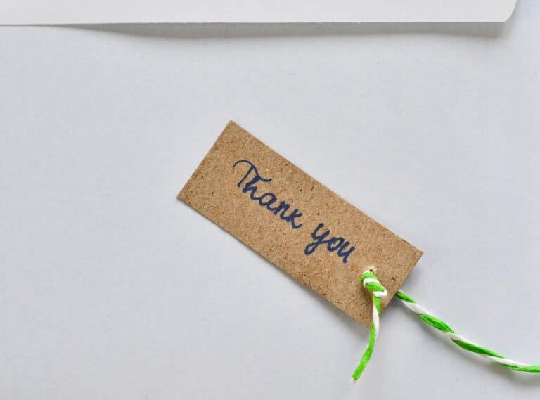 A card with a small note that reads "thank you" attached to it